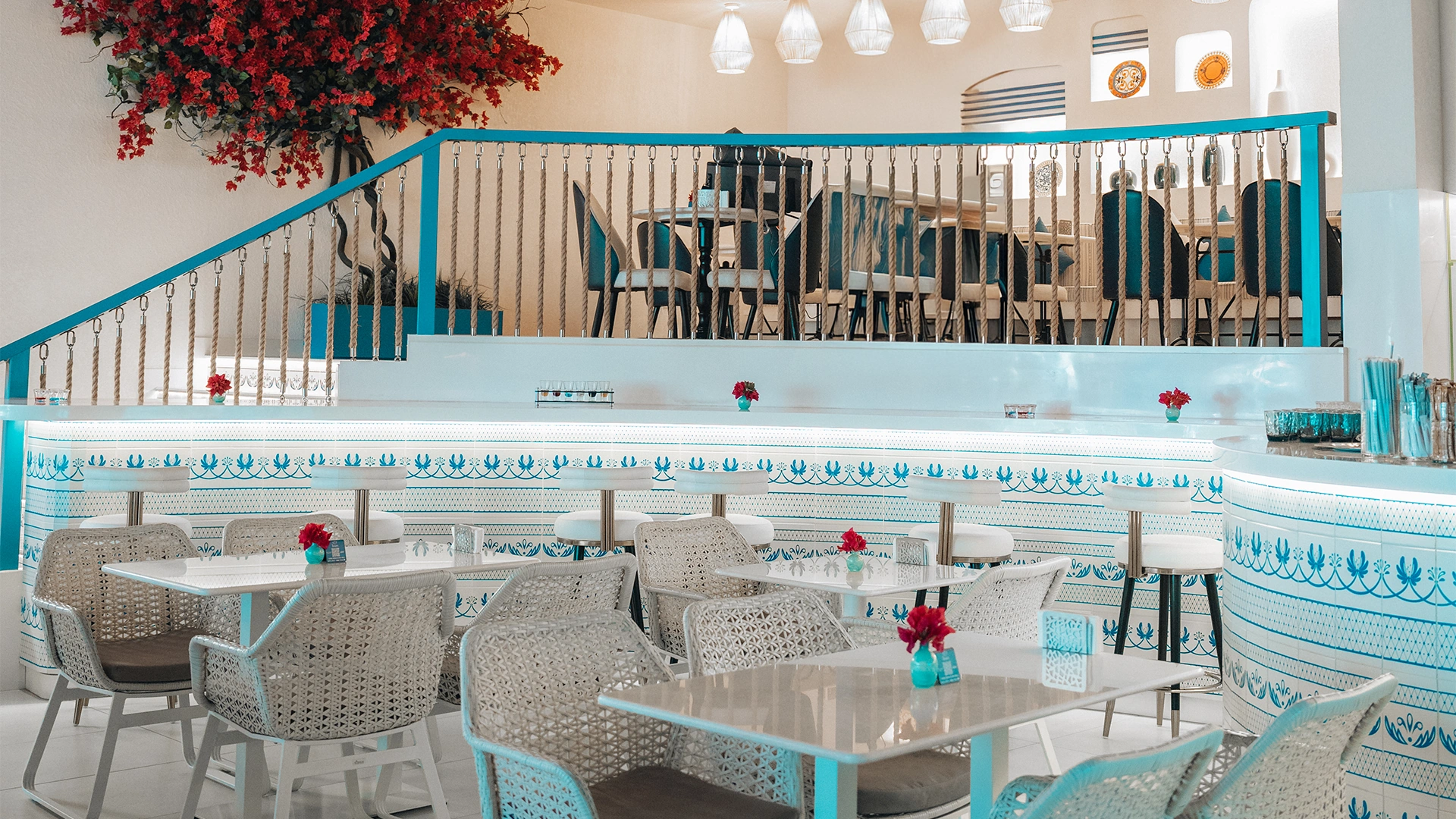 Guests enjoying dinner at elegantly set table with Mediterranean ambiance